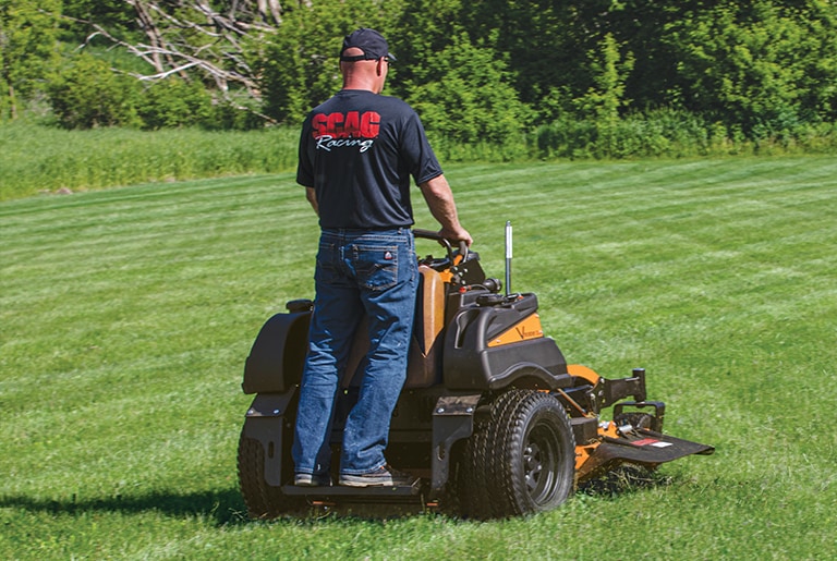 Man mowing a lawn using a V-Ride XL