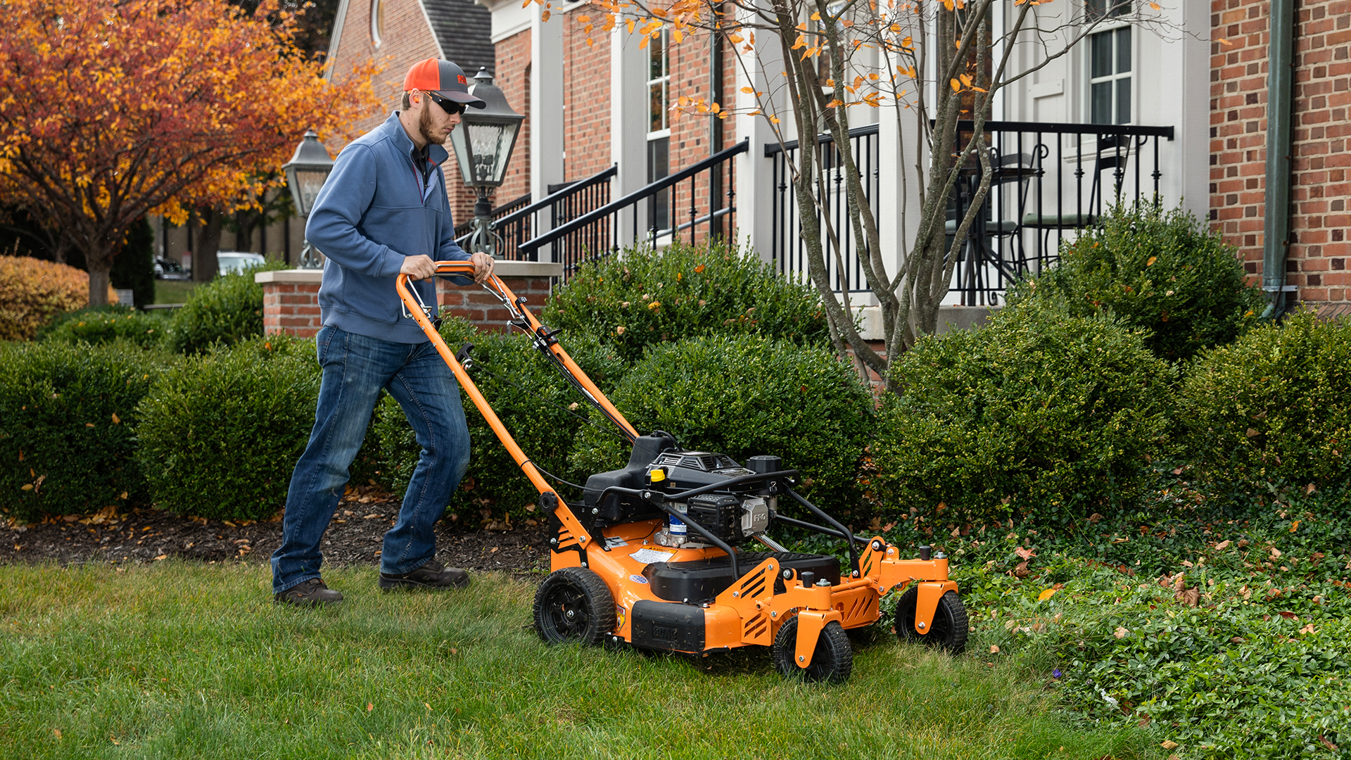 Image of a man pushing a SFCII-30 mower in a yard.